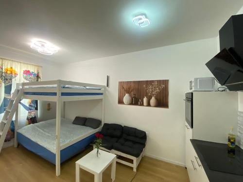 a small room with a bunk bed and a couch at NERi in Koper