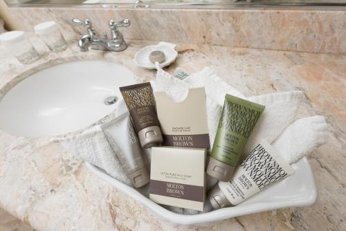 a bathroom sink with a pile of books on it at La Jolla Beach & Tennis Club in San Diego