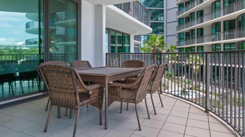 a table and chairs on the balcony of a building at Enjoy a 3-bedroom Bayfront Condo with Lazy River Indoor Pool Jacuzzis and Community Boat Dock for Personal or Rented Boats Plus Redeem in Free Activity Deals Daily in Orange Beach