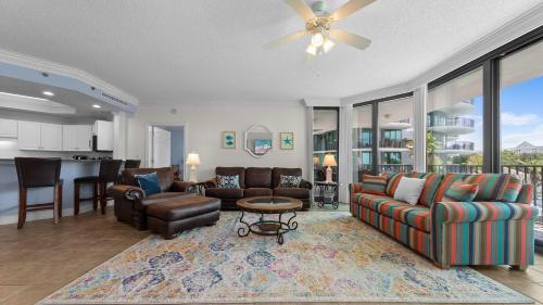 a living room with a couch and a table at Enjoy a 3-bedroom Bayfront Condo with Lazy River Indoor Pool Jacuzzis and Community Boat Dock for Personal or Rented Boats Plus Redeem in Free Activity Deals Daily in Orange Beach