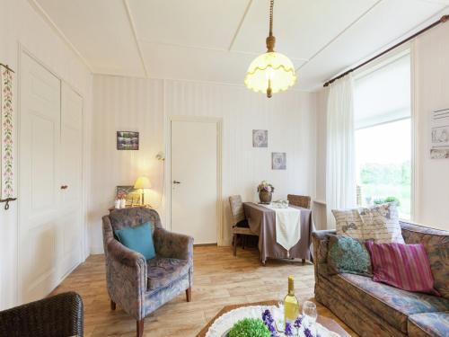 a living room with two couches and a table at leisure retrete with costal nature in Wemeldinge