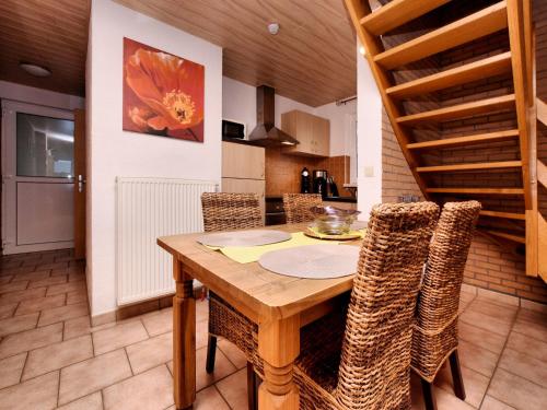 a dining room with a wooden table and chairs at Cosy Nature Retreat, Houffalize in Houffalize
