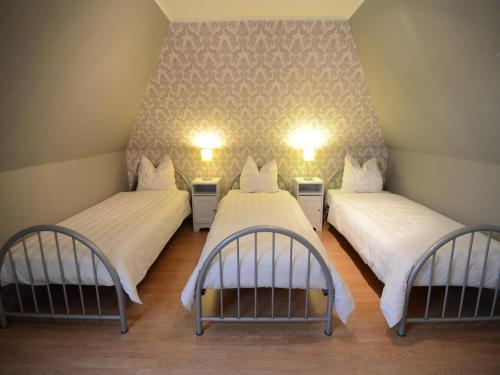 a room with two beds and two lights on the wall at Holiday Home in Zele near Laarne Castle in Zele