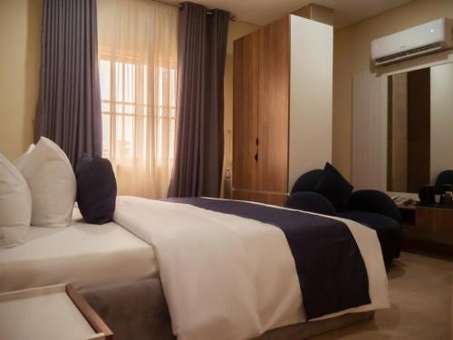 a hotel room with a bed and a window at Captain Residency in Lagos