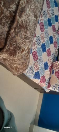 a close up of a quilt hanging from a ceiling at premanand mharaj marg Vrindavan Dham in Vrindāvan
