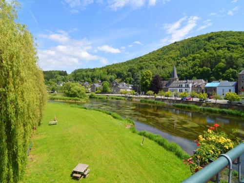a park next to a river in a town at Sunny Garden Cottage, Alle in Frahan