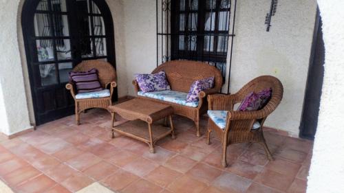a group of chairs and a table on a porch at Casa Lucia in Benissa