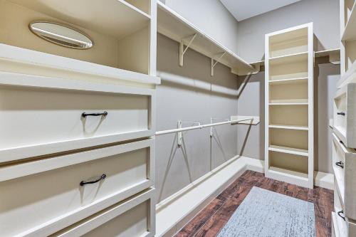 a walk in closet with white shelves and a mirror at 1 Mi to Vackar Stadium Roomy Retreat with Pool in Edinburg