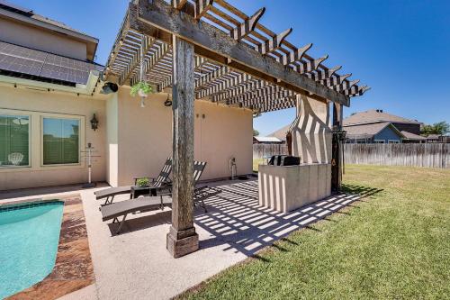 a pergola next to a pool in a yard at 1 Mi to Vackar Stadium Roomy Retreat with Pool in Edinburg