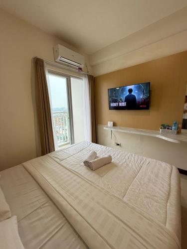 Ένα ή περισσότερα κρεβάτια σε δωμάτιο στο Citra Plaza Studio Near Nagoya Hill