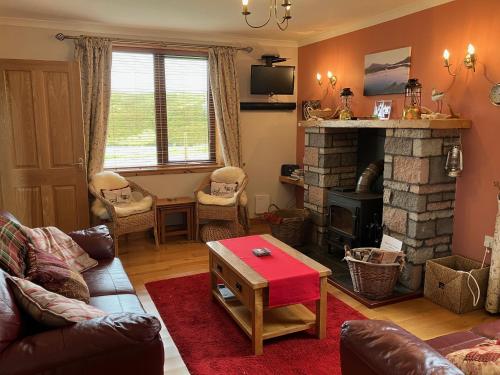 a living room with a couch and a fireplace at Sealladh Eabhal 