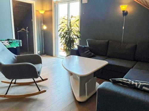 a living room with a couch and a table at 4 star holiday home in Auklandshamn in Vestvik