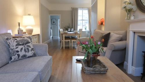 a living room with a couch and a table at Luxury living outside the city walls - sleeps six! in Chester