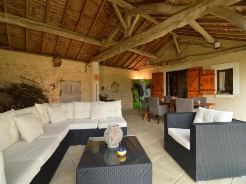 a living room with a white couch and a table at Holiday Home in Saint-Jean near Loire Castles in Frontenay-sur-Dive