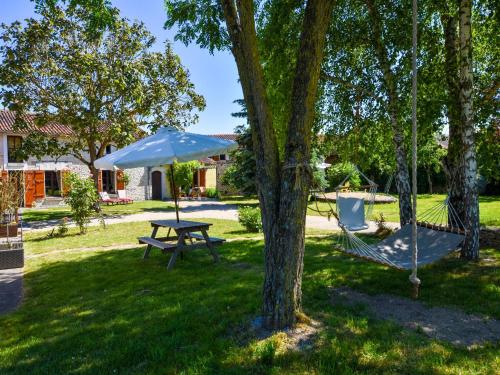 a hammock and an umbrella in a yard at Holiday Home in Saint-Jean near Loire Castles in Frontenay-sur-Dive