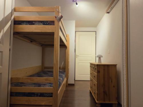 a room with a bunk bed and a staircase at Le Florian in Taninges