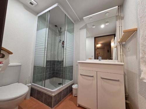 a bathroom with a shower and a toilet and a sink at Le Florian in Taninges