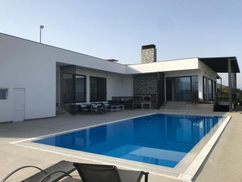 a swimming pool in the backyard of a house at DREAM VIEW Saguramo in Saguramo