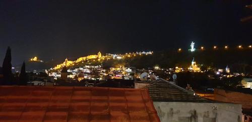 a view of a city at night with lights at Boutique Hotel Point in Tbilisi City