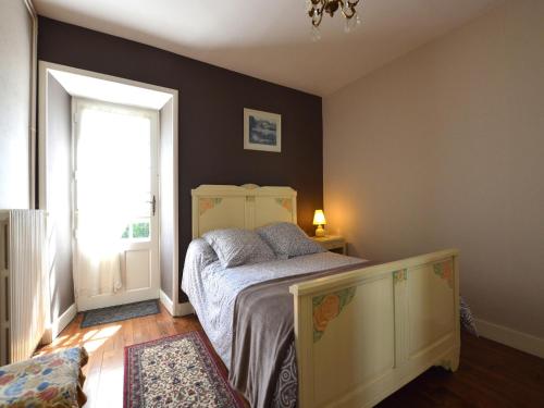 a bedroom with a bed and a window at Historic Tower Home in Brignac in Brignac-la-Plaine