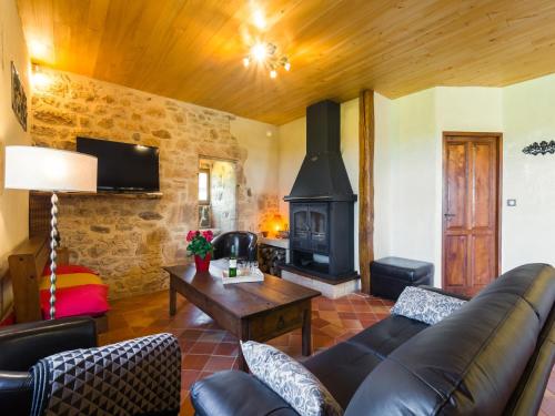 a living room with a couch and a fireplace at Mazeyrolles Forest Escape in Mazeyrolles