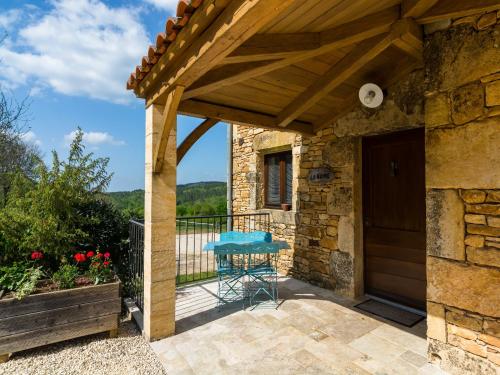 a patio with a wooden pergola and a table at Mazeyrolles Forest Escape in Mazeyrolles