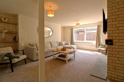 a living room with a couch and a table at Detached Home Near Kings Lynn in North Runcton