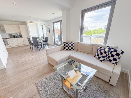 a living room with a couch and a table at Contemporary Apartments with Private Balconies in Hoxton near Shoreditch, Old Street, Islington by Staylio Ltd in London