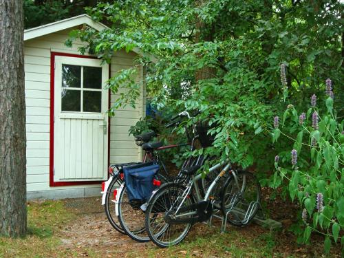 two bikes parked in front of a house at Holiday Home in Nunspeet near Forest in Nunspeet
