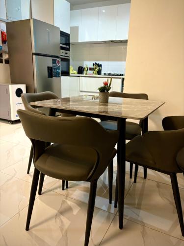 a dining room table and chairs in a kitchen at LB Homes in Mama