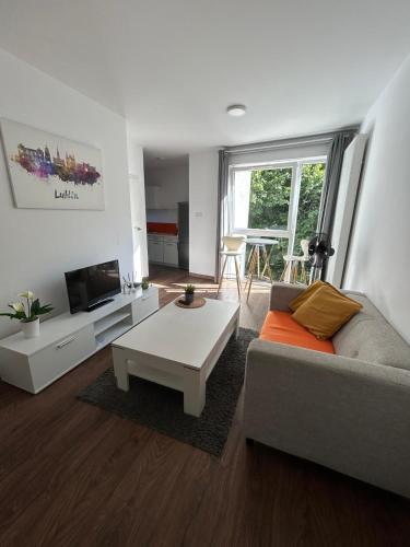 a living room with a couch and a table at Cube Apartamenty in Lublin