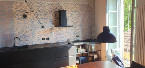 a kitchen with a sink and a table at Casa di Grazia in Intra