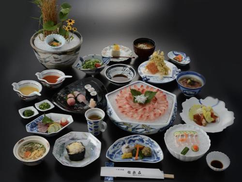 a group of plates of food on a table at Joy House in Imari