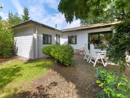 a house with a table and chairs in the yard at Chalet in Stegeren with Pool and Gardens in Stegeren
