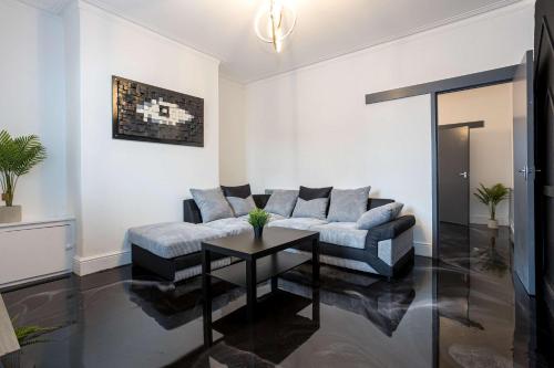 a living room with a couch and a table at Modern & Convenient 2 Bedroom House in St Helens in Saint Helens