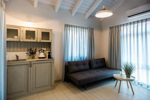 a living room with a couch and a kitchen at Ein Zivan Village Resort in Ein Zivan