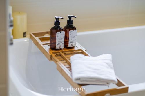 three bottles of soap sitting on a shelf in a bathroom at Bonnieview House, Tarves, Aberdeenshire 