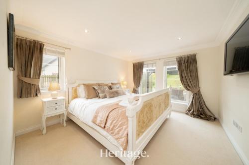 a white bedroom with a bed and a window at Bonnieview House, Tarves, Aberdeenshire 