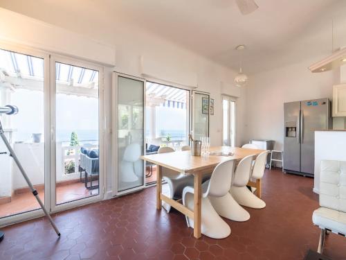 a kitchen and dining room with a table and chairs at Elegant Seaside Villa in Èze in Èze