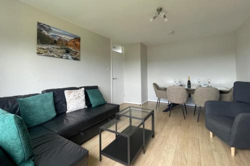a living room with a couch and a table at Skiddaw Heights in Keswick