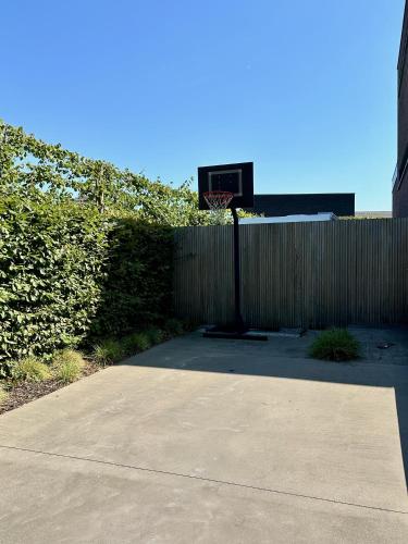 a basketball hoop in front of a fence at Villa Tussenin in Gistel
