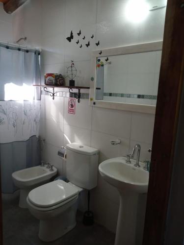 a bathroom with a toilet and a sink at Cabañas Universo in San Rafael