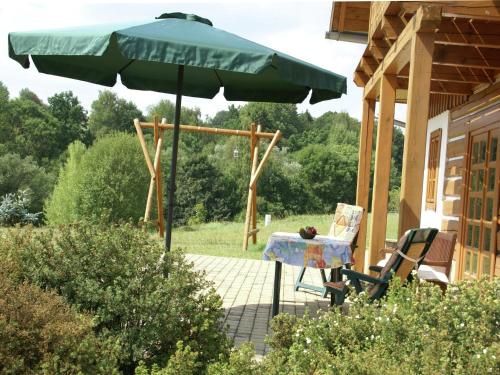 a table and an umbrella on a patio at Peaceful Mountain Holiday Stay in Stupná