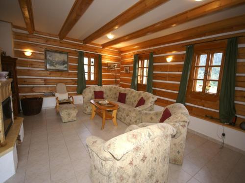 a living room with couches and a table at Peaceful Mountain Holiday Stay in Stupná