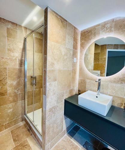 a bathroom with a sink and a shower at Le joli strasbourgeois in Caen