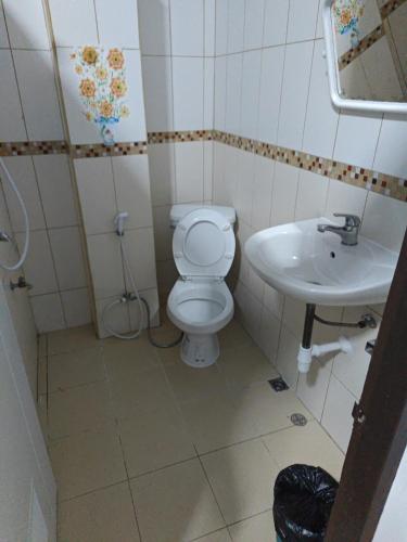 a small bathroom with a toilet and a sink at TM Room For Rent in Pattaya
