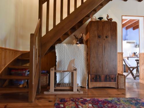 a room with a staircase and a wooden cabinet at Holiday Home in Le Châtelet with Pool in Le Châtelet