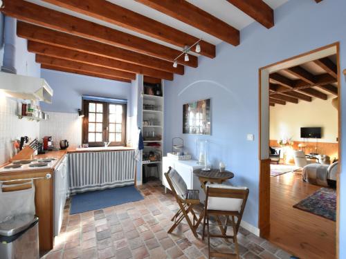 a kitchen and living room with wooden beams at Holiday Home in Le Châtelet with Pool in Le Châtelet