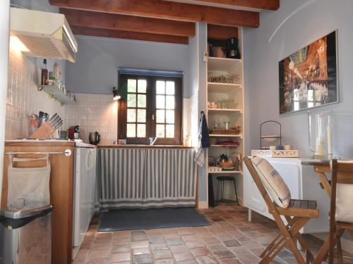 a kitchen with a radiator and a table and a chair at Holiday Home in Le Châtelet with Pool in Le Châtelet