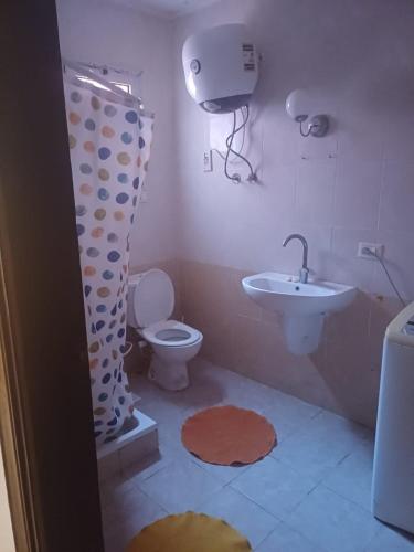 a bathroom with a toilet and a sink at North Coast chalet for rent in Dawwār Abū Duray‘ah ‘Abd al Karīm